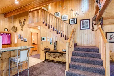 a staircase in a cabin with wooden walls at River Refuge in Wawona