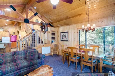 a dining room and living room with a table and chairs at River Refuge in Wawona