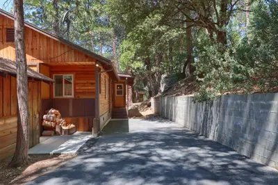 a driveway leading to a house with a fence at Bradley's Cabin in Wawona