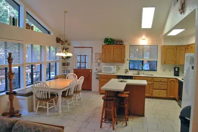 a kitchen and dining room with a table and chairs at Big Cedar in Wawona