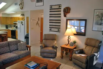 a living room with a couch and chairs and a table at Big Cedar in Wawona