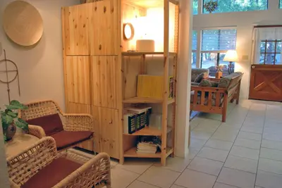 a living room with a book shelf with books at Big Cedar in Wawona