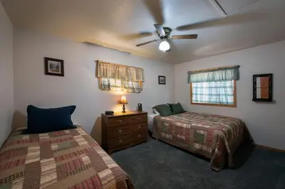 a bedroom with two beds and a ceiling fan at Wawona Cabin in Wawona