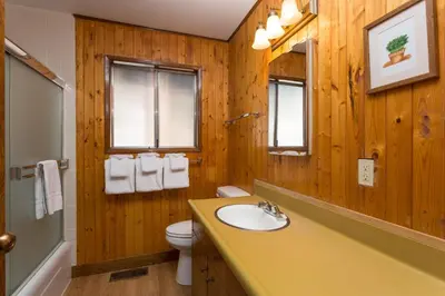 a wooden bathroom with a sink and a toilet at Bird's Eye View in Yosemite West