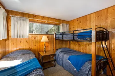 two bunk beds in a room with wooden walls at Bird's Eye View in Yosemite West