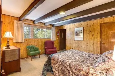 a bedroom with a bed and a desk and a chair at Bird's Eye View in Yosemite West
