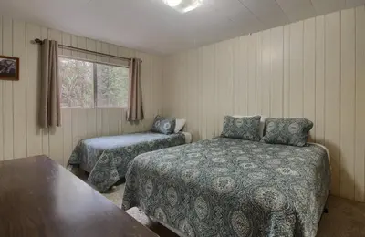 a bedroom with two beds and a window at Villarreal Retreat in Wawona