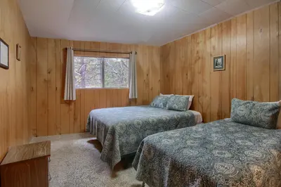 a bedroom with two beds and a window at Villarreal Retreat in Wawona