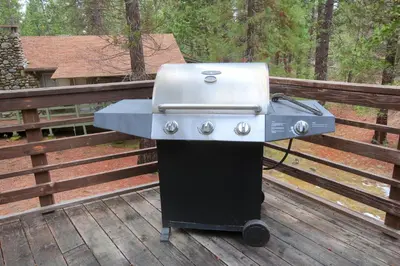 a grill sitting on top of a wooden deck at Villarreal Retreat in Wawona