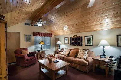 a living room with a couch and a table at The Terry Cabin in Wawona