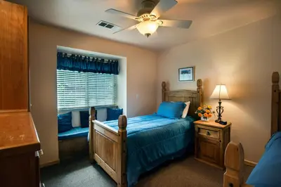 a bedroom with a bed and a ceiling fan at The Terry Cabin in Wawona