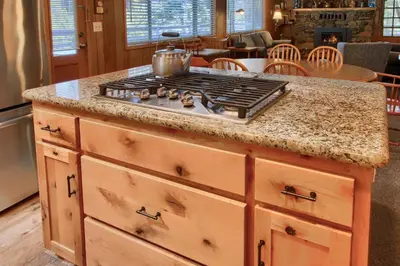 a kitchen with a stove top on a counter at Quail Meadow in Wawona