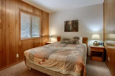 a bedroom with a bed and a window at Quail Meadow in Wawona