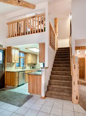 a kitchen with stairs leading up to a kitchen at Big Pine Lodge in Wawona