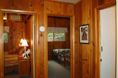 a bedroom with a bed and a room with a window at Dunning's Retreat in Wawona
