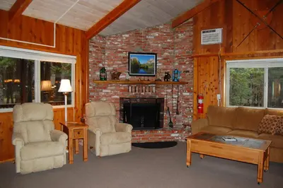 a living room with a couch and chairs and a fireplace at Dunning's Retreat in Wawona