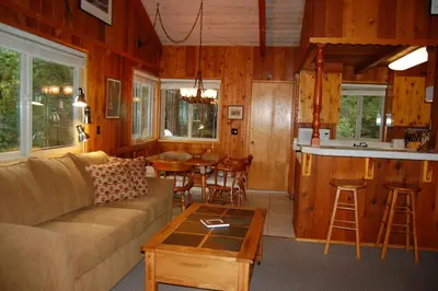 a living room with a couch and a table at Dunning's Retreat in Wawona