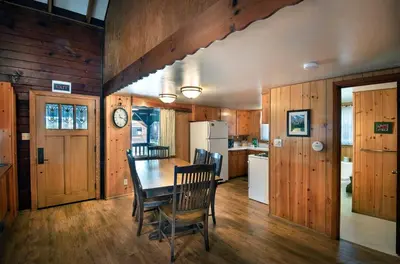 a kitchen and dining room with a table and chairs at Grandma's Cabin in Wawona