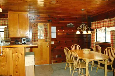 a kitchen and dining room with a table and chairs at Cubby's Den in Wawona