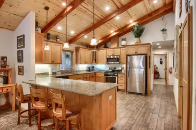 a large kitchen with wooden cabinets and a large island at Larkspur Lair in Wawona