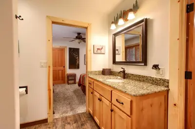 a bathroom with a sink and a mirror at Larkspur Lair in Wawona