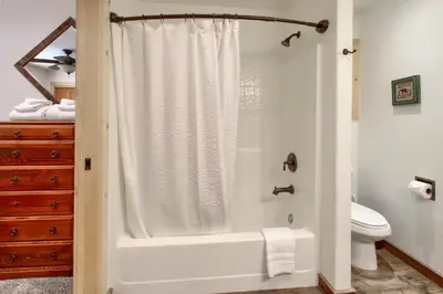 a bathroom with a shower and a toilet at Larkspur Lair in Wawona