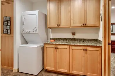 a kitchen with a refrigerator and a washer and dryer at Larkspur Lair in Wawona