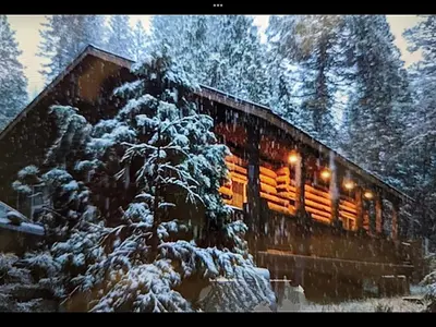 a train in the snow with lights on at The Mini Cabin in Wawona