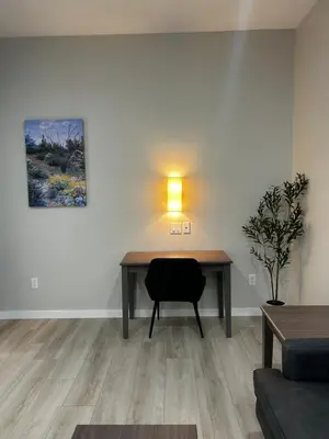 a room with a desk with a lamp and a chair at The Palisades Lodge of Big Pine in Big Pine