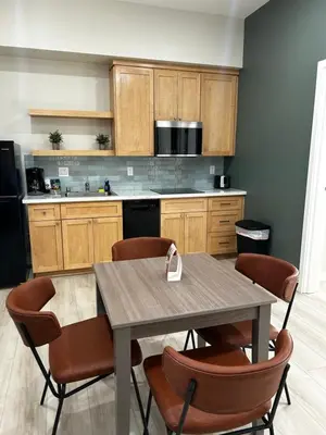 a kitchen with a table with chairs and a counter at The Palisades Lodge of Big Pine in Big Pine