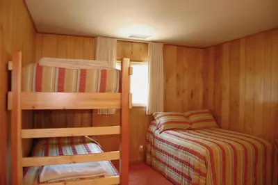 a small room with two bunk beds and a window at River Song in Wawona