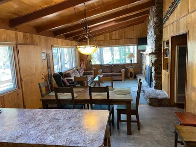 a living room with a table and chairs and a couch at Cutter's Edge in Wawona