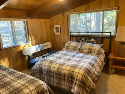 a bedroom with two beds and two windows at Cutter's Edge in Wawona