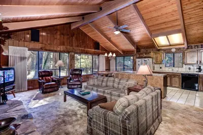 a living room with couches and a tv in a house at Coyle's Cabin in Wawona