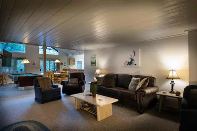 a living room with a couch and chairs and a table at The Last Resort in Wawona