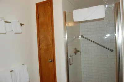 a bathroom with a shower with a glass door at Mountain Retreat in Wawona