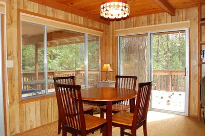 a dining room with a wooden table and chairs at Mountain Retreat in Wawona