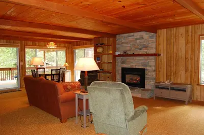 a living room with a couch and a fireplace at Mountain Retreat in Wawona