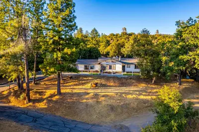 an aerial view of a house with trees at Hillside Sky Ranch Retreat 12 miles from Yosemite in Oakhurst