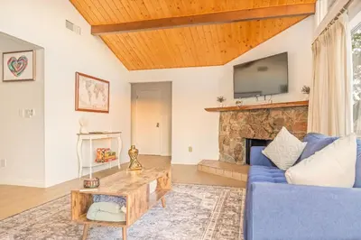 a living room with a blue couch and a fireplace at Hillside Sky Ranch Retreat 12 miles from Yosemite in Oakhurst