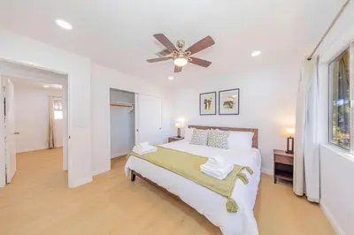 a white bedroom with a bed and a ceiling fan at Hillside Sky Ranch Retreat 12 miles from Yosemite in Oakhurst