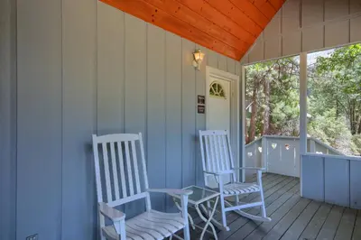 two chairs and a table on a porch at Edna's Hearts Desire in Wawona
