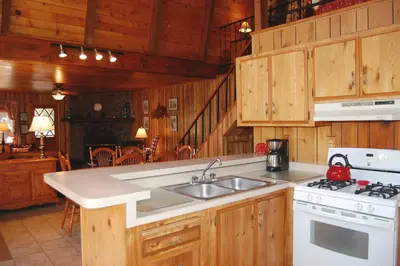 a kitchen with a sink and a stove top oven at Manzanita Lodge in Wawona