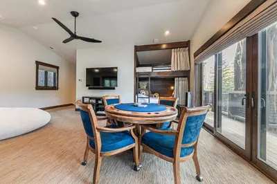 a dining room with a table and chairs and a bed at Aqua Vista Lakefront Estate by Tahoe Getaways - 6 BR in Carnelian Bay w Buoy, Pier & Game Room in Carnelian Bay