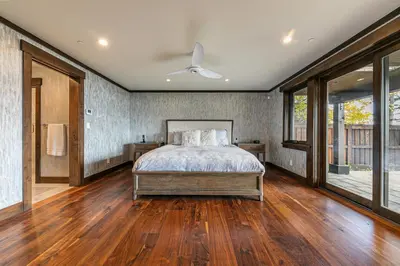 a bedroom with a bed and a ceiling fan at Aqua Vista Lakefront Estate by Tahoe Getaways - 6 BR in Carnelian Bay w Buoy, Pier & Game Room in Carnelian Bay