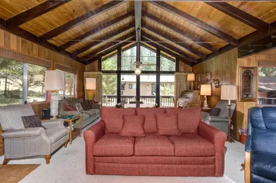 a living room with a red couch and chairs at Mountain Memory in Wawona