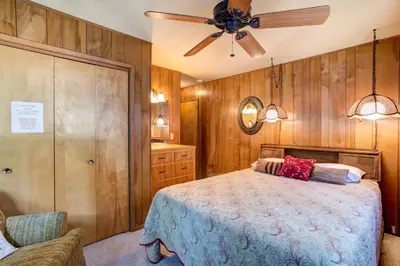 a bedroom with a bed and a ceiling fan at Mountain Memory in Wawona
