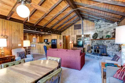 a living room with a couch and a fireplace at Mountain Memory in Wawona