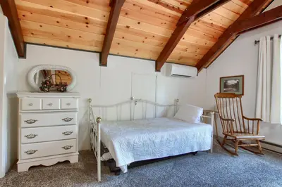 a bedroom with a bed and a wooden ceiling at Spindler's Chalet in Wawona