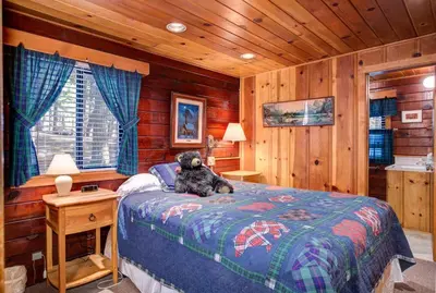 a teddy bear sitting on a bed in a bedroom at Mia Mora in Wawona